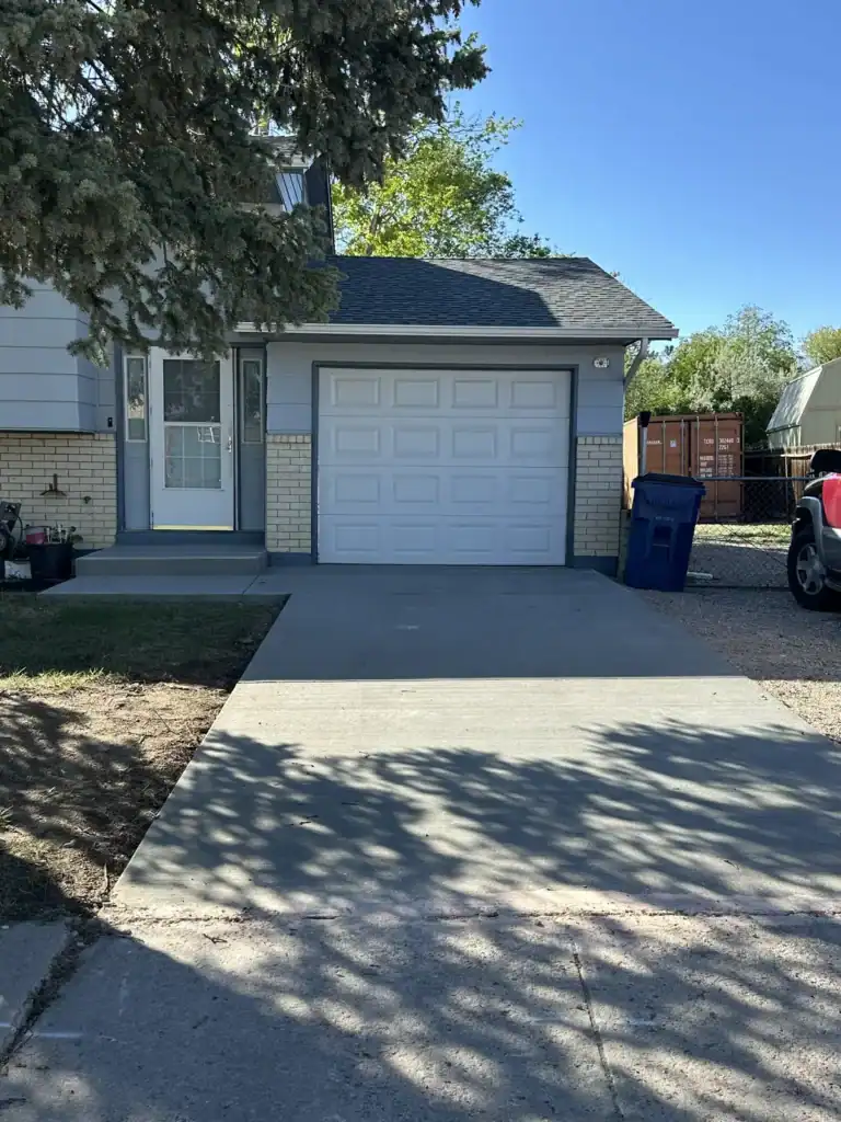 Broom-finish concrete driveway with a two-car garage