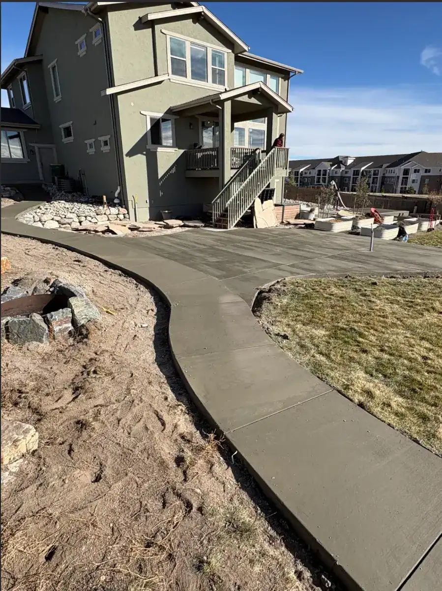 Curved concrete walkway connecting patio areas
