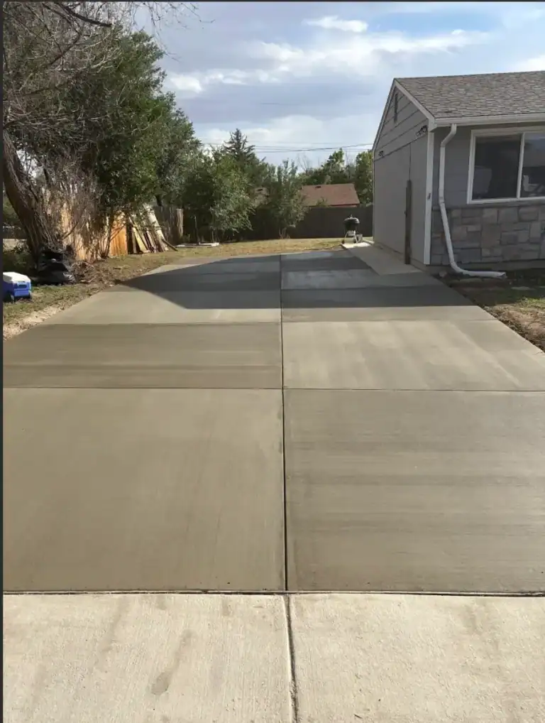 New concrete driveway installation by CrestStone Concrete in a residential yard.