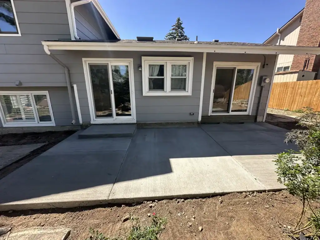 Backyard concrete patio graded to drain away from the house