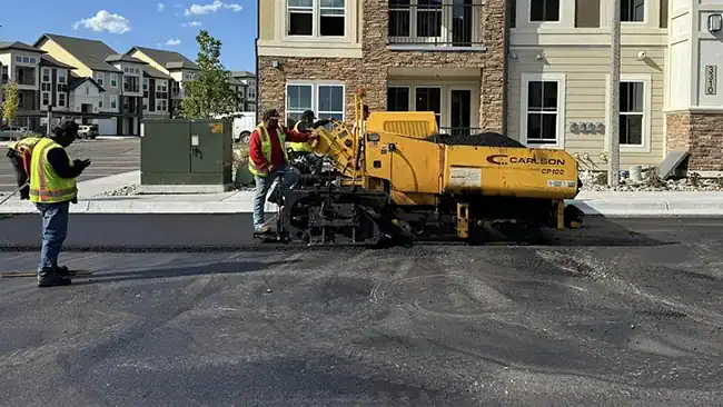 Asphalt paver laying a new overlay during an asphalt resurfacing project in Colorado Springs